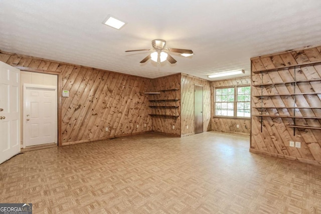 2228 Walker Dr, Lawrenceville, GA 30043 - unfurnished living room with ceiling fan, baseboards, wooden walls, and parquet flooring