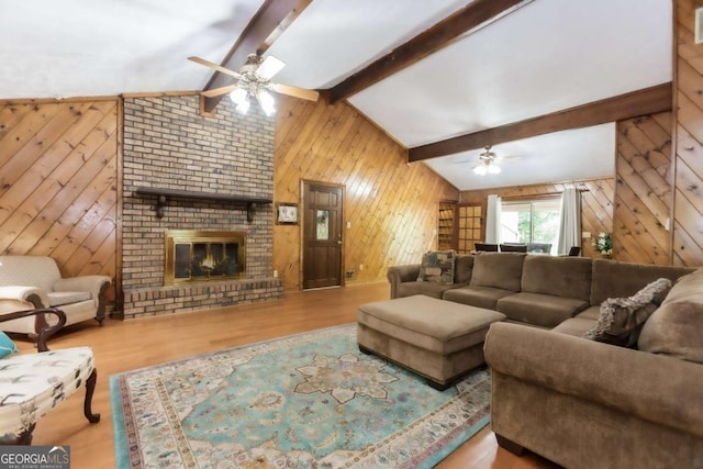2228 Walker Dr, Lawrenceville, GA 30043 - living area with ceiling fan, wooden walls, wood finished floors, and a fireplace