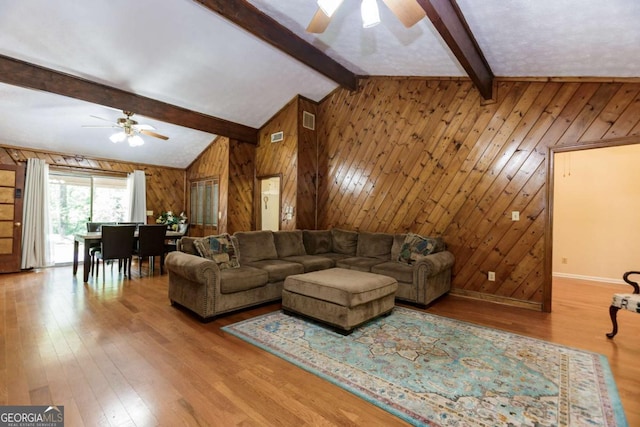 2228 Walker Dr, Lawrenceville, GA 30043 - living room featuring ceiling fan, wooden walls, wood finished floors, and baseboards