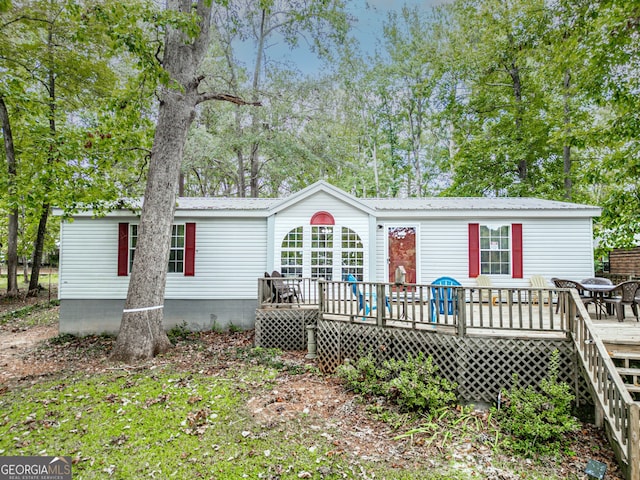 194 Phillips Dr, Eatonton, GA 31024 - rear view of property featuring a deck and metal roof