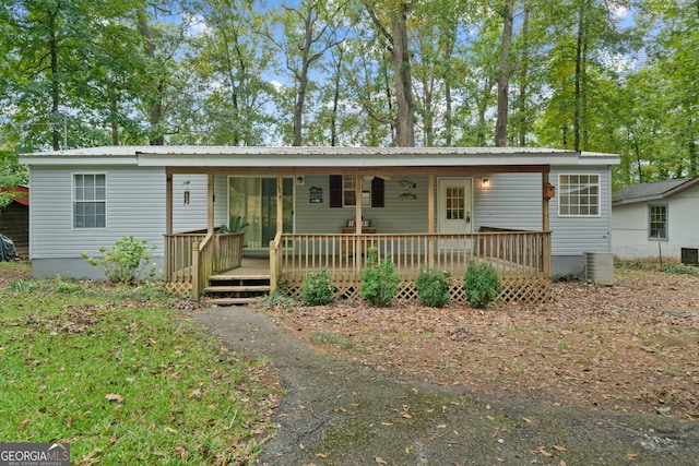 194 Phillips Dr, Eatonton, GA 31024 - view of front of home featuring central AC unit, metal roof, and a deck