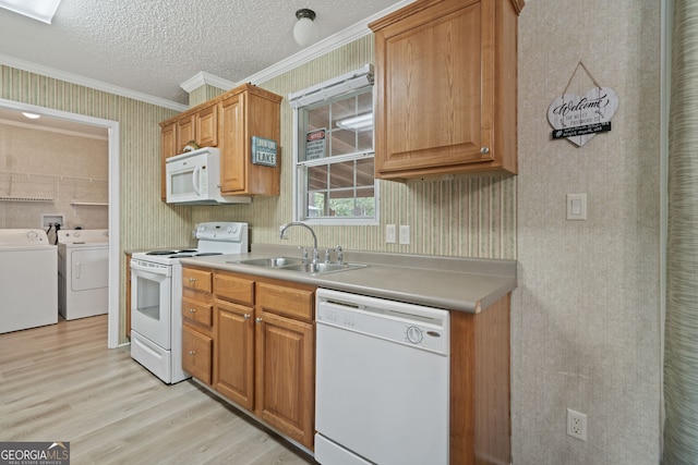 194 Phillips Dr, Eatonton, GA 31024 - kitchen with white appliances, separate washer and dryer, wallpapered walls, a sink, and light wood finished floors