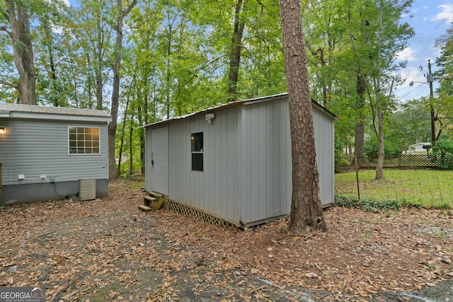 194 Phillips Dr, Eatonton, GA 31024 - view of shed featuring fence and central AC