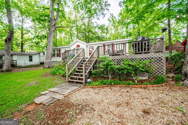 194 Phillips Dr, Eatonton, GA 31024 - back of property with a deck, a yard, and stairs