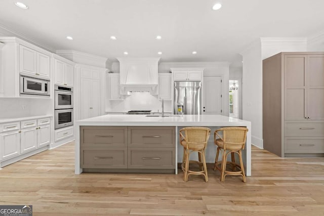 8745 Islesworth Ct, Duluth, GA 30097 - kitchen featuring built in appliances, a sink, custom range hood, recessed lighting, and light countertops