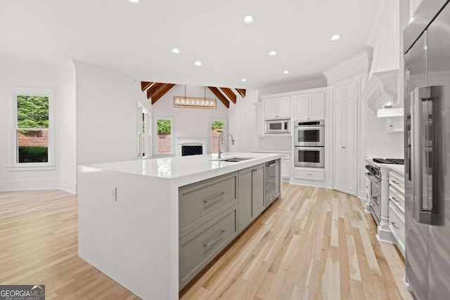8745 Islesworth Ct, Duluth, GA 30097 - kitchen with a sink, high quality appliances, gray cabinets, light wood-type flooring, and recessed lighting