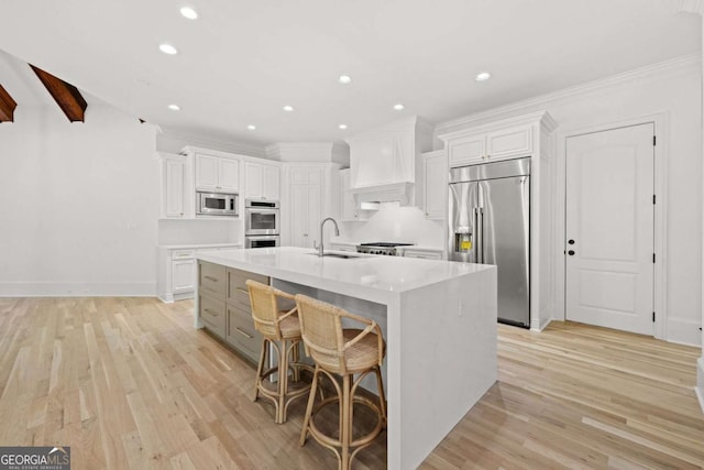8745 Islesworth Ct, Duluth, GA 30097 - kitchen featuring built in appliances, a sink, premium range hood, white cabinetry, and recessed lighting