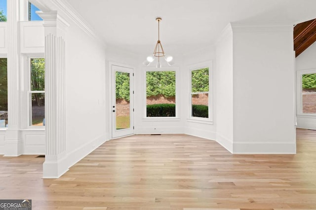 8745 Islesworth Ct, Duluth, GA 30097 - unfurnished dining area with a chandelier, light wood finished floors, and ornamental molding