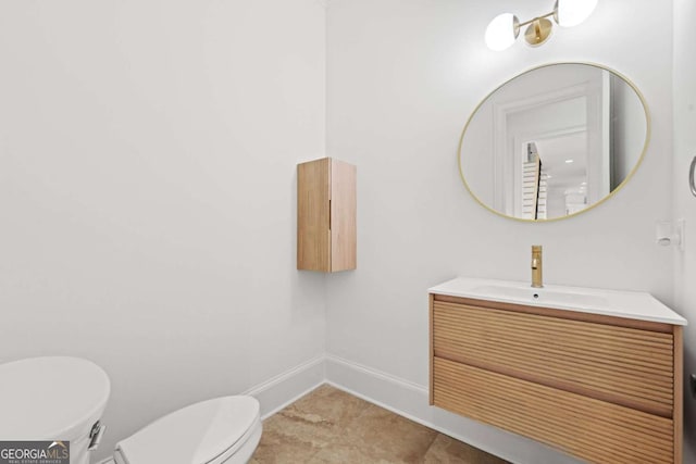 8745 Islesworth Ct, Duluth, GA 30097 - bathroom with toilet, vanity, and baseboards