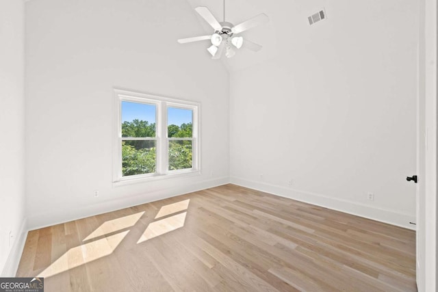 8745 Islesworth Ct, Duluth, GA 30097 - unfurnished room with wood finished floors, ceiling fan, baseboards, and vaulted ceiling