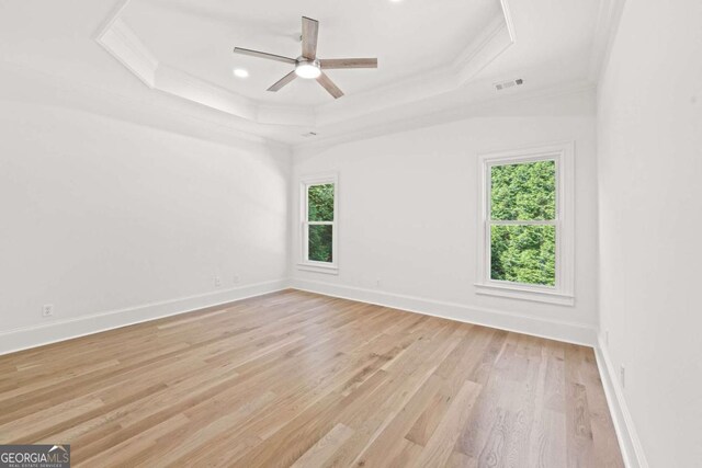 8745 Islesworth Ct, Duluth, GA 30097 - unfurnished room with ornamental molding, a raised ceiling, plenty of natural light, light wood finished floors, and ceiling fan
