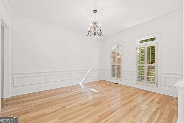 8745 Islesworth Ct, Duluth, GA 30097 - unfurnished dining area with a chandelier, wood finished floors, ornamental molding, wainscoting, and a decorative wall