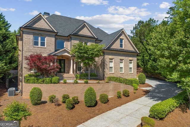 8745 Islesworth Ct, Duluth, GA 30097 - craftsman-style home featuring brick siding, covered porch, a chimney, and a fenced front yard