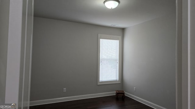605 Lanshire Dr, Alpharetta, GA 30004 - empty room featuring plenty of natural light, dark wood finished floors, and baseboards