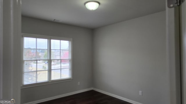 605 Lanshire Dr, Alpharetta, GA 30004 - empty room featuring baseboards and dark wood-style floors