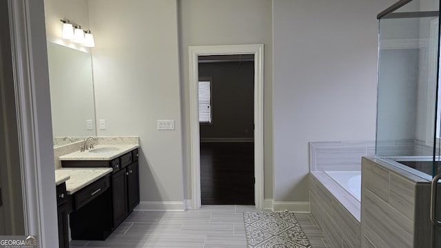 605 Lanshire Dr, Alpharetta, GA 30004 - bathroom with vanity, a garden tub, baseboards, and tile patterned floors