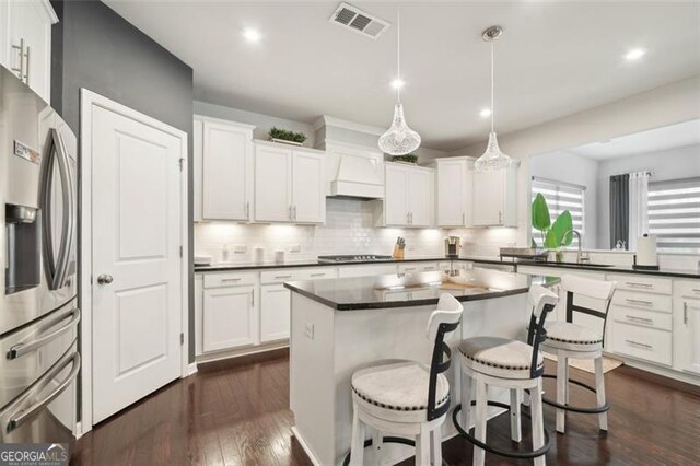 130 W Pier Way, Fayetteville, GA 30214 - kitchen with stainless steel fridge with ice dispenser, dark countertops, decorative backsplash, cooktop, and a kitchen breakfast bar