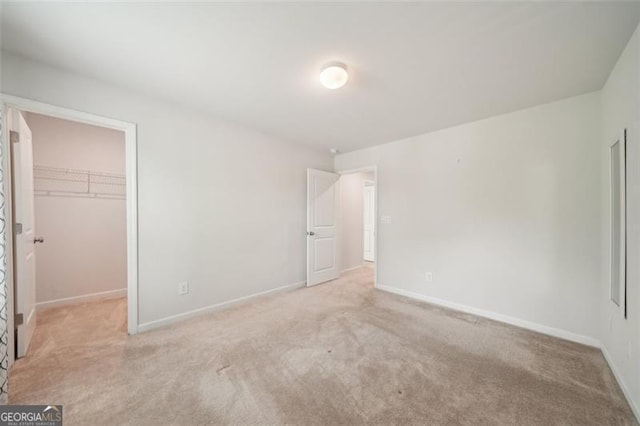 130 W Pier Way, Fayetteville, GA 30214 - unfurnished bedroom with carpet flooring, a spacious closet, and baseboards