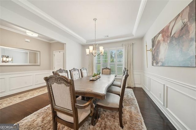 130 W Pier Way, Fayetteville, GA 30214 - dining space with a tray ceiling, a chandelier, dark wood-style floors, a decorative wall, and wainscoting