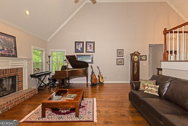 living room featuring high vaulted ceiling, dark wood finished floors, ornamental molding, a brick fireplace, and baseboards