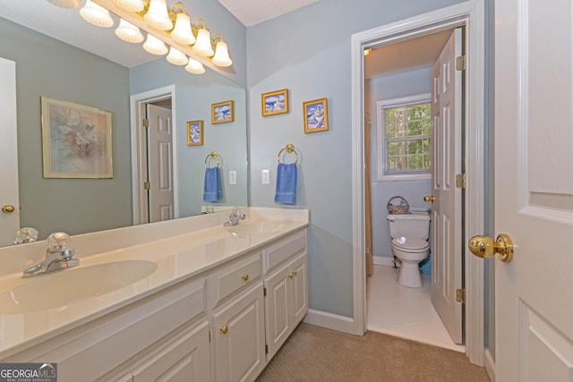 full bathroom featuring toilet, baseboards, and double vanity