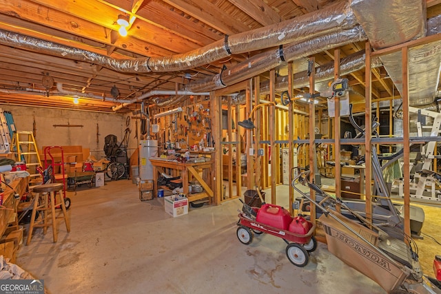 basement featuring gas water heater and a workshop area