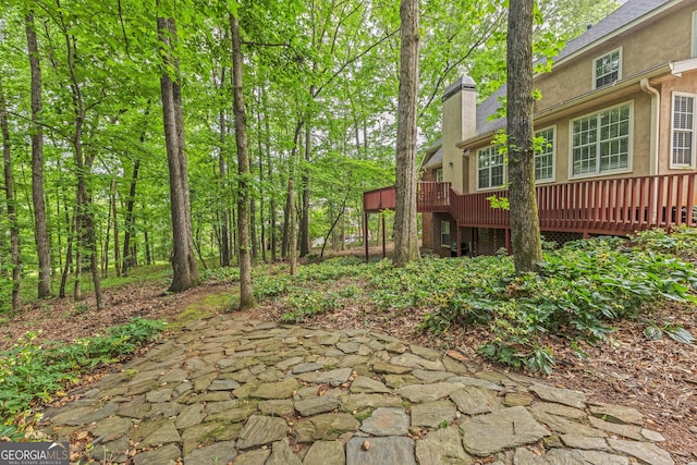 view of yard with a deck and a patio