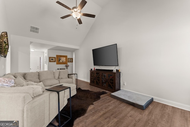 living area with high vaulted ceiling, wood finished floors, ceiling fan, and baseboards
