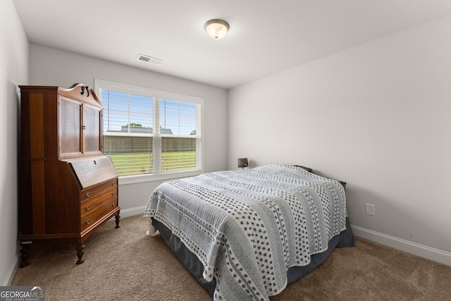 bedroom with carpet flooring and baseboards