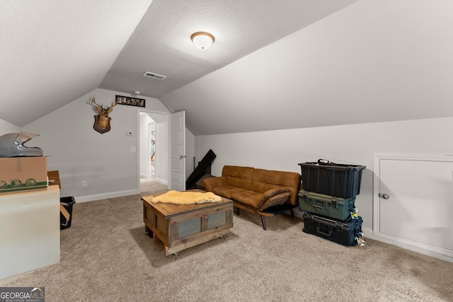 carpeted living room with vaulted ceiling, a textured ceiling, and baseboards