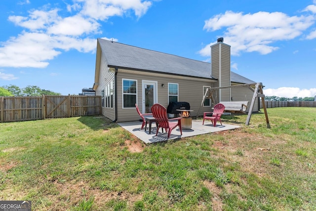 back of house with a patio and a chimney