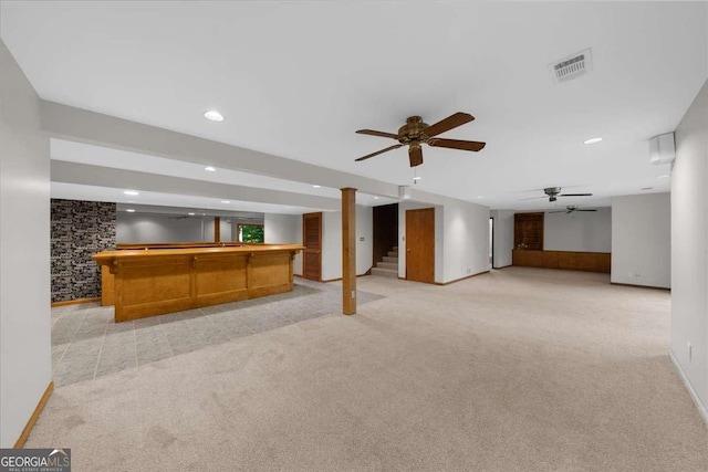finished below grade area featuring bar area, light colored carpet, recessed lighting, baseboards, and ceiling fan