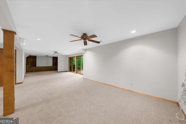 unfurnished living room with light colored carpet, recessed lighting, baseboards, and a ceiling fan