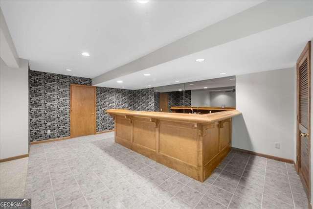indoor wet bar with baseboards, recessed lighting, and wallpapered walls