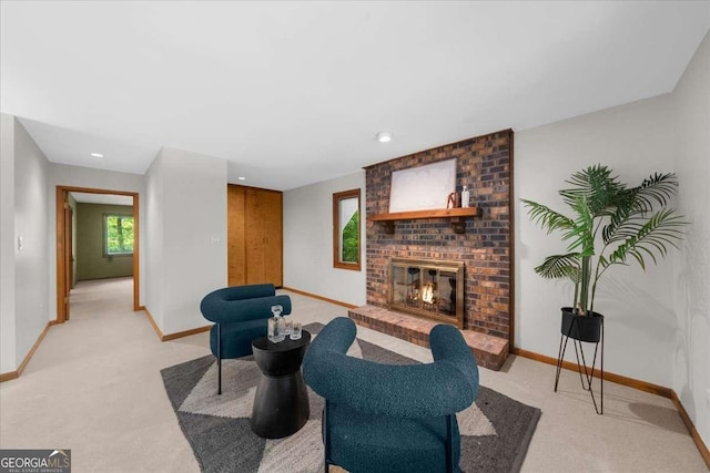 living room featuring baseboards, light carpet, a fireplace, and recessed lighting