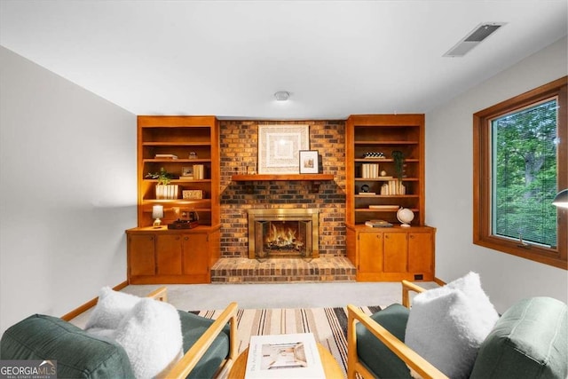 living area featuring built in shelves, a fireplace, and baseboards