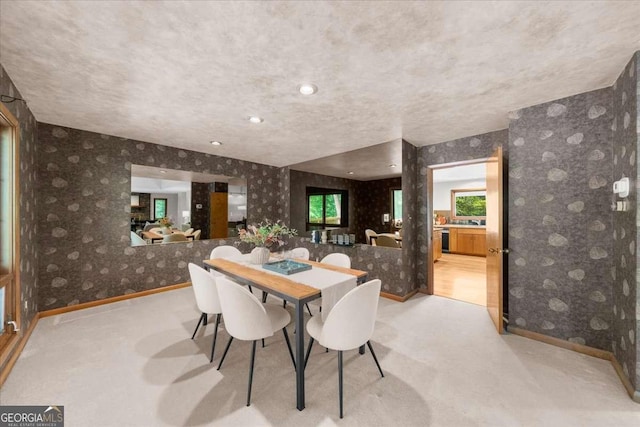 dining area with wallpapered walls, baseboards, and carpet