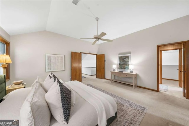 bedroom with light colored carpet, vaulted ceiling, a ceiling fan, and baseboards