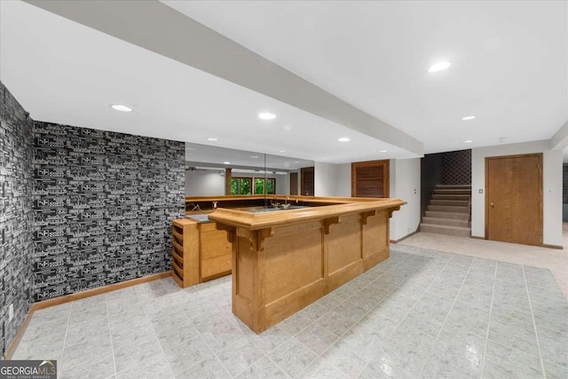 kitchen featuring a breakfast bar area, recessed lighting, butcher block countertops, and a kitchen island