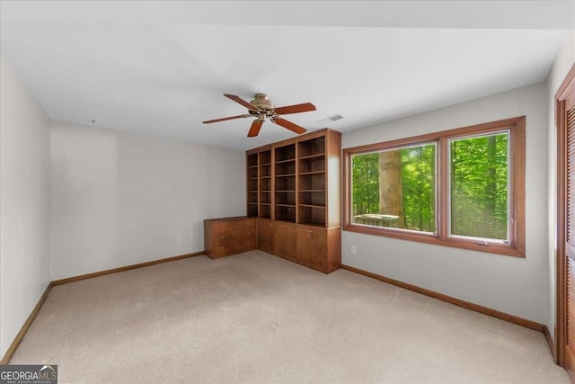 empty room with light carpet, baseboards, and ceiling fan