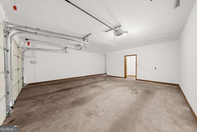 garage featuring baseboards and a garage door opener