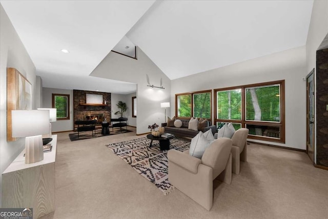 living room with carpet, a fireplace, high vaulted ceiling, and baseboards