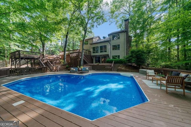 swimming pool with stairway, a deck, and an outdoor hangout area