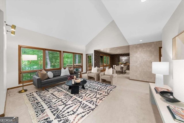 living room featuring carpet flooring, high vaulted ceiling, and baseboards