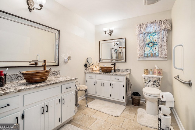 375 Buckwood Trl, Cornelia, GA 30531 - bathroom featuring two vanities, tile patterned flooring, and baseboards