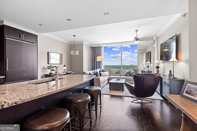 3630 Peachtree Rd NE Unit 1909, Atlanta, GA 30326 - living room featuring dark wood finished floors, crown molding, ceiling fan, and floor to ceiling windows