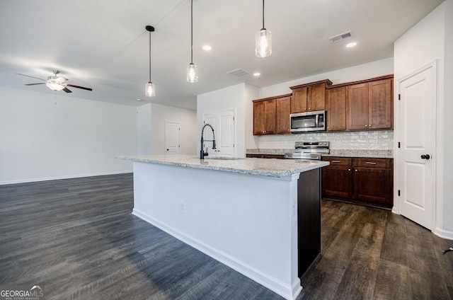 180 Oliver Dr, Locust Grove, GA 30248 - kitchen featuring appliances with stainless steel finishes, ceiling fan, dark wood finished floors, decorative backsplash, and a sink