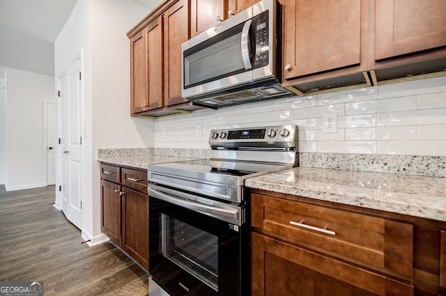 180 Oliver Dr, Locust Grove, GA 30248 - kitchen with appliances with stainless steel finishes, dark wood-style floors, tasteful backsplash, light stone counters, and baseboards