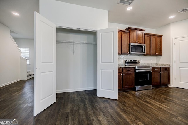 180 Oliver Dr, Locust Grove, GA 30248 - kitchen featuring stainless steel appliances, dark wood-type flooring, decorative backsplash, and baseboards