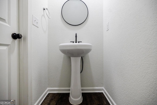 180 Oliver Dr, Locust Grove, GA 30248 - bathroom featuring baseboards and wood finished floors